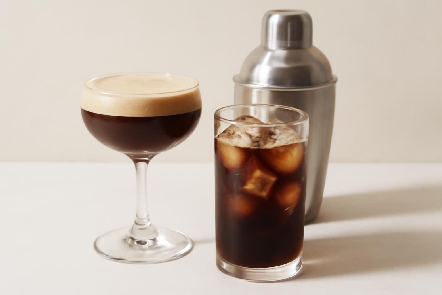 シェケラートのグラスと氷入りアイスコーヒーを並べた静物。飲み物と器具だけ